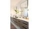 Modern bathroom featuring double sinks with wood grain cabinets, white countertops, and large mirrors at 3681 Hamilton Mill Rd, Buford, GA 30519