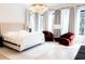 Bright bedroom featuring a tufted headboard, sitting area, and natural lighting at 3681 Hamilton Mill Rd, Buford, GA 30519