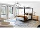 Bright bedroom featuring a four-poster bed, ample natural light, and modern decor at 3681 Hamilton Mill Rd, Buford, GA 30519