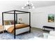 Bright bedroom featuring a four-poster bed, ample natural light, and modern decor at 3681 Hamilton Mill Rd, Buford, GA 30519