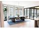 Elegant dining area with modern chandelier, sleek table, and sliding doors to the patio at 3681 Hamilton Mill Rd, Buford, GA 30519