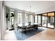 Bright dining room features stylish light fixture, large windows, and contemporary furnishings at 3681 Hamilton Mill Rd, Buford, GA 30519