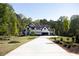 Beautiful modern home with a manicured lawn and lush landscaping at 3681 Hamilton Mill Rd, Buford, GA 30519