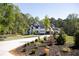 Beautiful modern home with a manicured lawn and lush landscaping at 3681 Hamilton Mill Rd, Buford, GA 30519