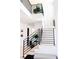 Bright foyer with staircase featuring modern black railings and light wood treads, creating an open and airy entrance at 3681 Hamilton Mill Rd, Buford, GA 30519