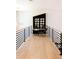 Hallway seating area with modern light fixture, reading nook, and black metal railing at 3681 Hamilton Mill Rd, Buford, GA 30519