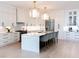 Bright and airy kitchen features white cabinets, stainless appliances, and a large center island at 3681 Hamilton Mill Rd, Buford, GA 30519