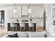 Modern kitchen with white cabinetry, a central island with seating, and stainless steel appliances at 3681 Hamilton Mill Rd, Buford, GA 30519