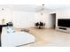 Open-concept living room features a modern sofa, dining area, and contemporary lighting fixture at 3681 Hamilton Mill Rd, Buford, GA 30519