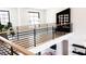 Stylish loft area with modern railings, comfortable seating, and a view of the lower level; an inviting space at 3681 Hamilton Mill Rd, Buford, GA 30519