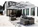Outdoor patio with a covered dining area, lounge seating, and stylish geometric patterned flooring at 3681 Hamilton Mill Rd, Buford, GA 30519
