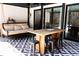 Cozy outdoor patio with a porch swing, dining table, and stylish geometric patterned flooring at 3681 Hamilton Mill Rd, Buford, GA 30519