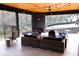 Inviting covered patio with wood ceiling, fan, fireplace, and comfortable seating, perfect for outdoor living at 3681 Hamilton Mill Rd, Buford, GA 30519