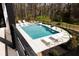 Sparkling in-ground pool and spa surrounded by lounge chairs and manicured landscaping; a backyard paradise at 3681 Hamilton Mill Rd, Buford, GA 30519