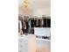 Bright walk-in closet featuring custom shelving, drawer units and unique modern light fixture at 3681 Hamilton Mill Rd, Buford, GA 30519