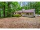 View of house in treed private backyard with stairs and landscaping at 641 Charing Cross Dr, Marietta, GA 30066