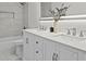 Bathroom featuring double vanity, tub with shower, recessed shelf, and bright modern lighting at 641 Charing Cross Dr, Marietta, GA 30066