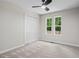 Bright bedroom features neutral walls, plush carpet, ceiling fan and double window at 641 Charing Cross Dr, Marietta, GA 30066