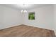 A well-lit dining room featuring hardwood floors and a modern chandelier at 641 Charing Cross Dr, Marietta, GA 30066