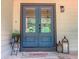 Inviting double front doors with welcome mat, potted plant, and decorative lanterns at 641 Charing Cross Dr, Marietta, GA 30066
