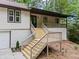 Inviting front entrance with wooden stairs leading to a stylish, covered porch at 641 Charing Cross Dr, Marietta, GA 30066