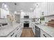 Modern kitchen with white cabinets, granite countertops, stainless steel appliances, and hardwood floors at 641 Charing Cross Dr, Marietta, GA 30066