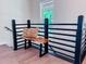 Hallway landing with a window and a built-in bench with black railing at 641 Charing Cross Dr, Marietta, GA 30066