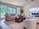 Cozy living room with large windows, a comfortable sofa, and an adjacent modern kitchen at 641 Charing Cross Dr, Marietta, GA 30066