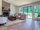 Comfortable living room featuring a stone fireplace, wood flooring, and sliding glass doors to outside at 641 Charing Cross Dr, Marietta, GA 30066