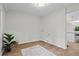 Neutral utility room featuring hardwood floors, natural light, and space for storage at 641 Charing Cross Dr, Marietta, GA 30066