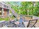 View of deck with rocking chairs on back patio and landscaped backyard at 70 Parkside Cir, Marietta, GA 30068