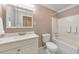 Bathroom featuring a shower-tub combo, a white vanity, and a large mirror, providing a clean and functional space at 70 Parkside Cir, Marietta, GA 30068