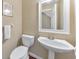 Powder room showcasing a pedestal sink and toilet with a white towel at 70 Parkside Cir, Marietta, GA 30068