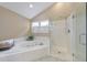 Well lit bathroom offers a relaxing soaking tub, and a glass enclosed shower with neutral tile surround at 70 Parkside Cir, Marietta, GA 30068