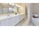 Bathroom showcasing double sinks, large mirrors, and white cabinetry that offers space and convenience for daily routines at 70 Parkside Cir, Marietta, GA 30068
