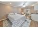 Bright bedroom features a patterned bed, hardwood floors, a ceiling fan, and access to a sink at 70 Parkside Cir, Marietta, GA 30068