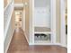 Hallway with coat rack nook, a bench with storage baskets, and a glimpse of a bright kitchen at 70 Parkside Cir, Marietta, GA 30068