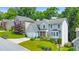 View of a well-maintained house with lush green lawn, mature trees, and neighborhood setting at 70 Parkside Cir, Marietta, GA 30068