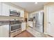 Well-lit kitchen featuring stainless steel appliances, white cabinetry, and hardwood floors at 70 Parkside Cir, Marietta, GA 30068