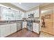 Updated kitchen with white cabinetry, stainless steel appliances, and views into the dining area at 70 Parkside Cir, Marietta, GA 30068