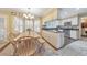 Bright eat-in kitchen featuring white cabinetry and stainless steel appliances with breakfast nook at 70 Parkside Cir, Marietta, GA 30068