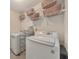 Functional laundry room with modern washer and dryer, plus shelving, ensuring efficient and organized laundry care at 70 Parkside Cir, Marietta, GA 30068