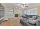 Bright living room with built-in shelving, cozy sofa, ceiling fan, and plantation shutters at 70 Parkside Cir, Marietta, GA 30068