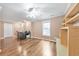 Well-lit office space featuring hardwood floors, a ceiling fan, a built-in shelf and a large window at 70 Parkside Cir, Marietta, GA 30068