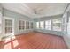 The spacious sunroom features wood flooring, large windows, and a ceiling fan, perfect for relaxation at 70 Parkside Cir, Marietta, GA 30068