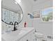 Modern bathroom featuring new fixtures, stylish vanity, and decorative mirror at 2723 Horseshoe Creek Sw Dr, Marietta, GA 30064