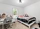 Bright bedroom featuring a cozy bed, modern desk, and natural light from the window at 2723 Horseshoe Creek Sw Dr, Marietta, GA 30064