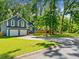 Charming two-story home featuring a two-car garage, well-maintained lawn, and mature trees providing ample shade at 2723 Horseshoe Creek Sw Dr, Marietta, GA 30064