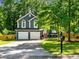 Charming two-story home with a two car garage, well-maintained lawn, mature trees, and a paved driveway at 2723 Horseshoe Creek Sw Dr, Marietta, GA 30064