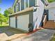 Close-up view of a home's side exterior highlighting a two-car garage and landscaped pathway to the front door at 2723 Horseshoe Creek Sw Dr, Marietta, GA 30064